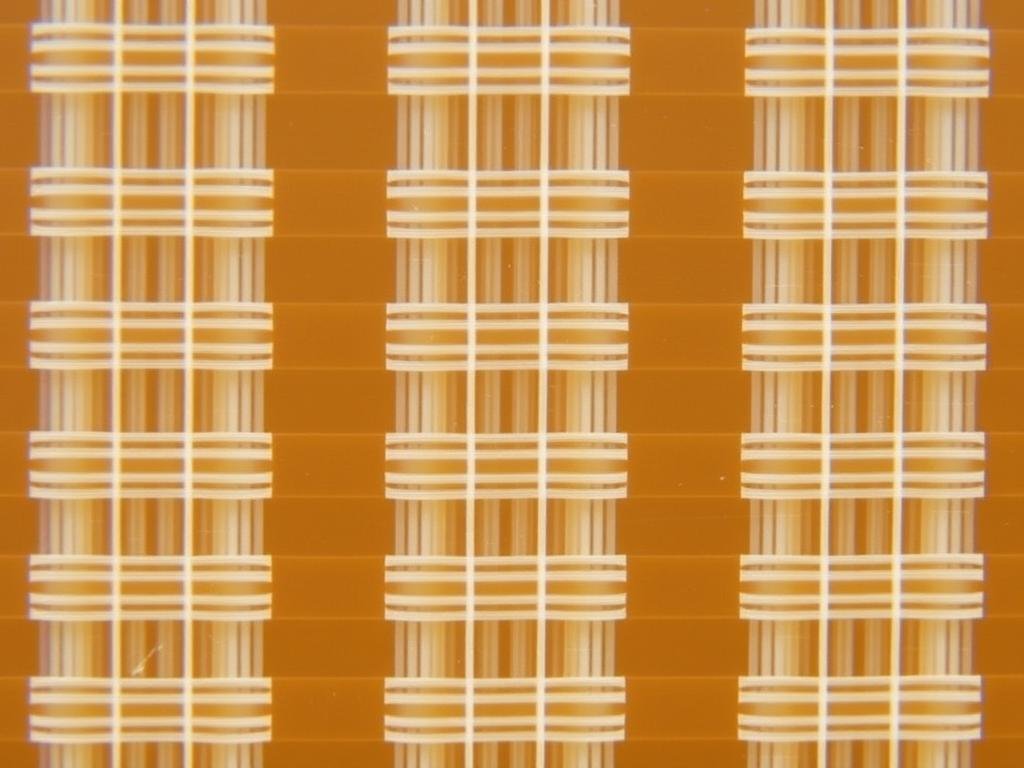 FR-4 PCB laminate material sample showing the characteristic woven fiberglass structure