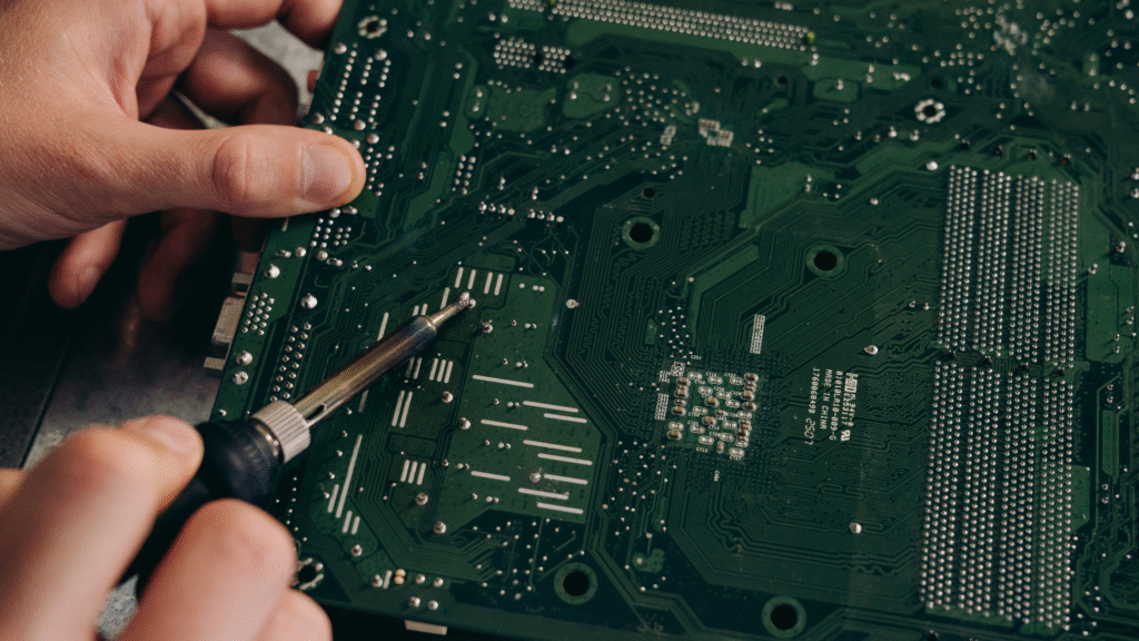 Human hands with electronic components on PCB